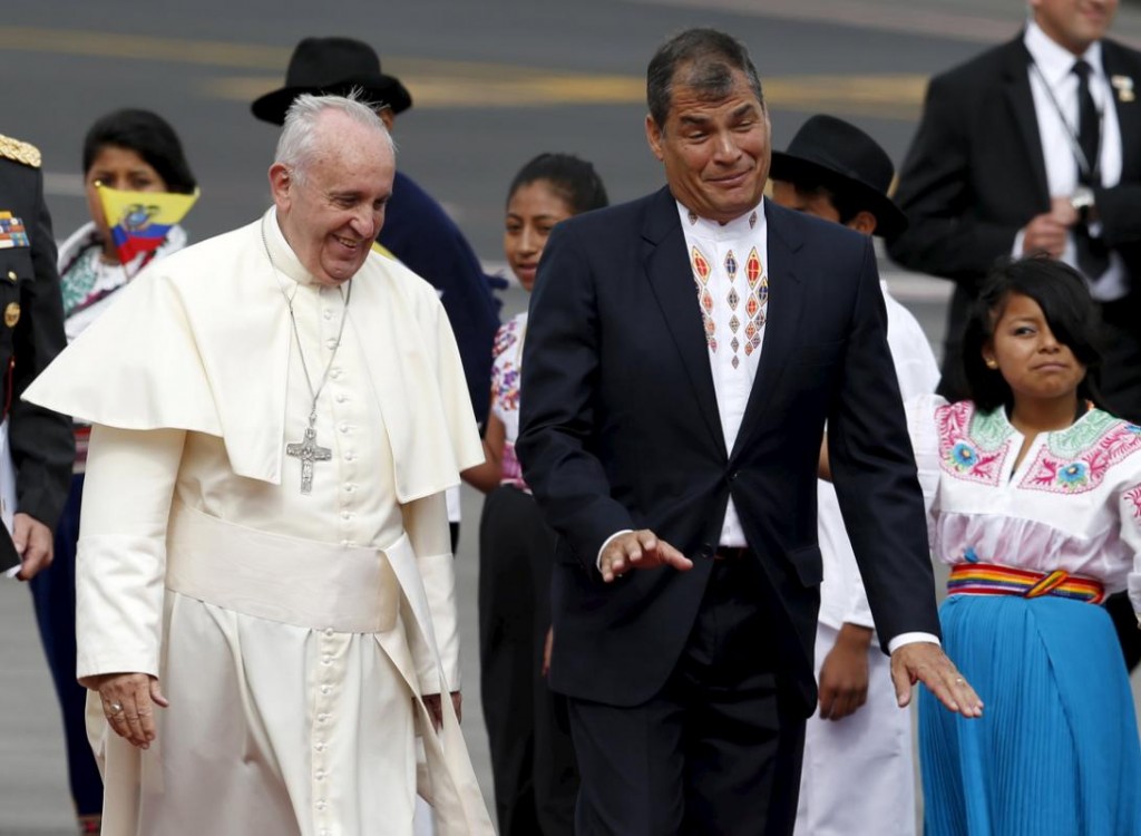 Pope Francis and Ecuador's President Rafael Correa walk after Pope Francis landed in Quito